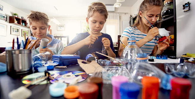 Family members making crafts with plastic and paper products