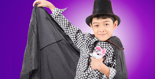 A child magician making a stuff bunny disappear