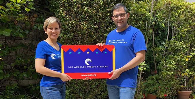 LAPL librarians - Ramin and Toktam holding large LAPL library card