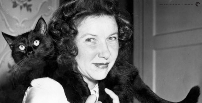 women with a black cat slung over her shoulders