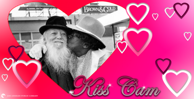 Kiss cam hearts around a couple kissing