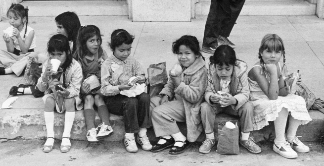 Children eating lunch b & w photo from 1983