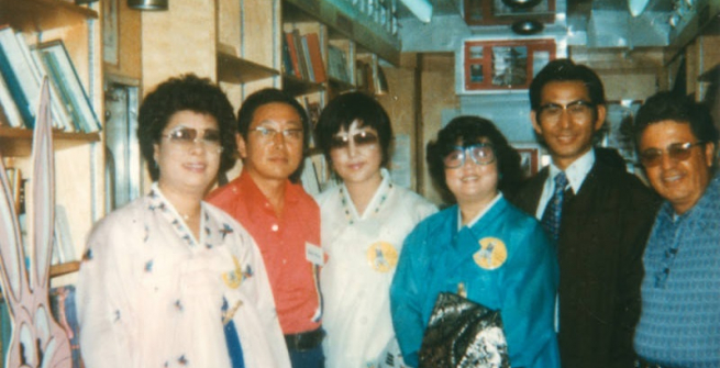 Korean Americans and library staff inside a Los Angeles Public Library Bookmobile that is participating in an annual Korean parade.