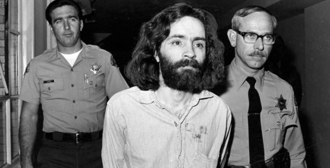 Charles Manson being lead away by deputies