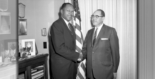 Tom Bradley (left) shakes hands with William Byron Rumford
