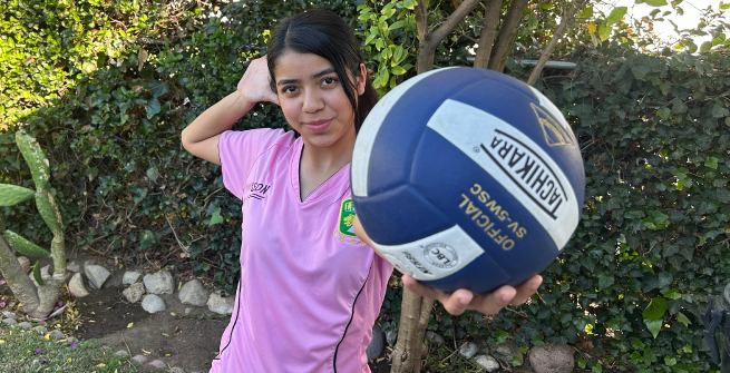 Sofia Perez holdingup a soccer ball