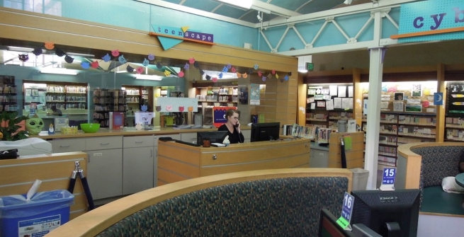Senior Librarian Mary McCoy at the Teen'Scape Desk