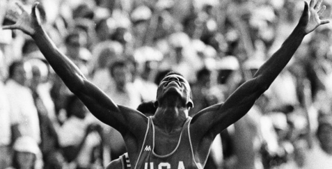 Carl Lewis raises his arms in victory at the LA 84 olympics