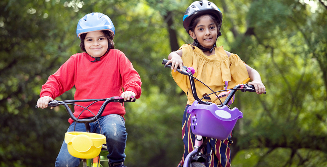 Two kids happy on their bikes