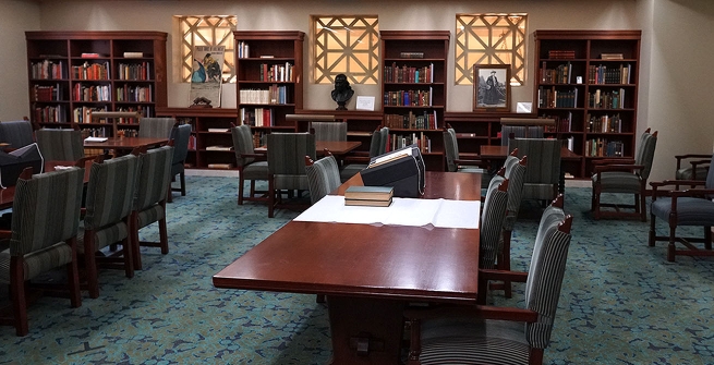 In the Rare Books room, rare books are set on top a white cloth over a table for a preview.