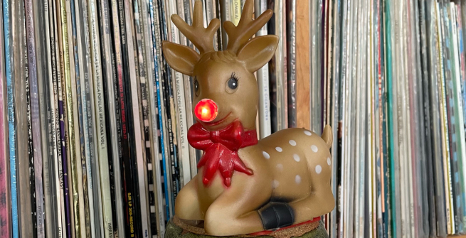 record wall with a giant Rudolph ornament in front