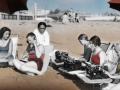 1934 colorized picture of people at the beach with typewriters