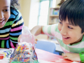 Happy kids working on a volcano experiment