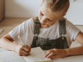 Young girl writing in her journal