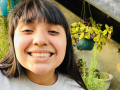 a smiling teen in a garden