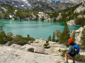 hiker looking at a vista with a lake and mountains