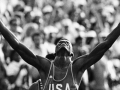 Carl Lewis raises his arms in victory at the LA 84 olympics