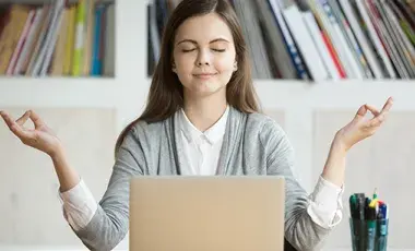 Image of teen student meditating in front of computer