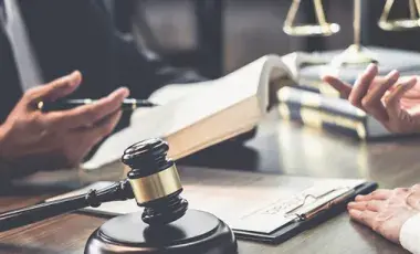 Two people with books discussing law