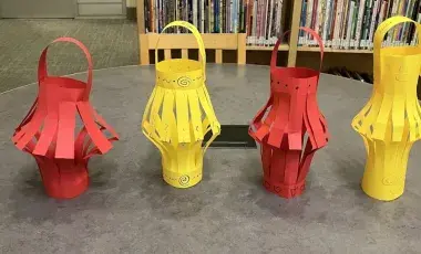 Red and yellow paper lanterns on a table