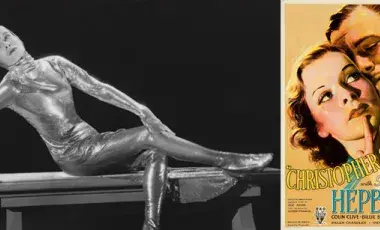 Katherine Hepburn in a silver costume alongside the movie poster for the film, Christopher Strong