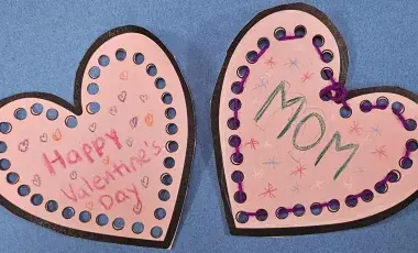 two pink hearts with mom and happy valentine's written on them. 