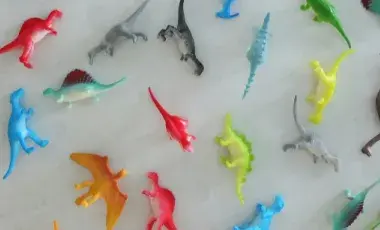 various colored dinosaur toys
