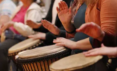 hands playing Drum in circle