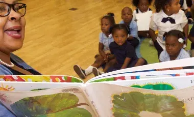 librarian reading a book to children
