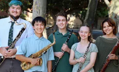 shows 5 people each holding a reed instrument