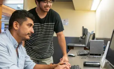 Two men using a computer