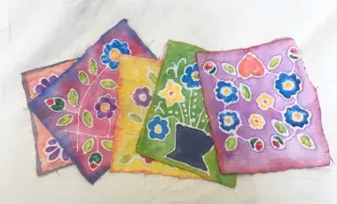 several fabric pieces done in batik style artwork