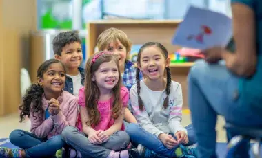 kids smiling while listening to a story