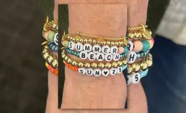 Image of bracelets on a wrist including bracelets with letter beads to spell words.