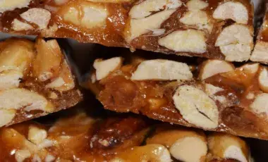 A close up view of pieces of almond brittle in a stack