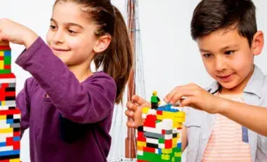 Two kids building with legos 