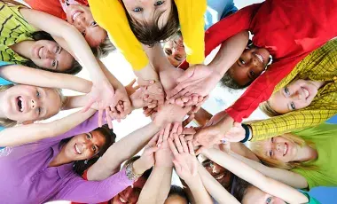 Many people holding outstretched hands