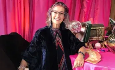 bright pink back ground, woman smiling 
