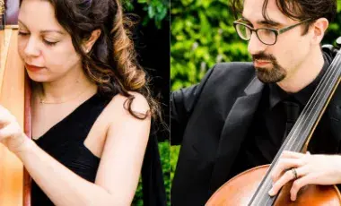 A female harpist and a male cellist play together. 