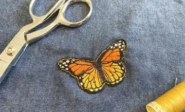 Butterfly patch sewn onto a piece of denim