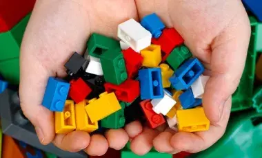 Two hands holding building blocks