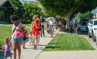 dogs and humans parade around the library