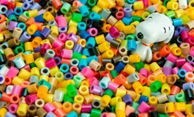 Colorful plastic beads with a cartoon dog among them