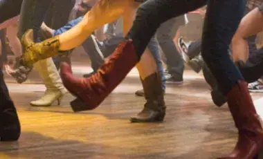 legs and feet with cowboy boots line dancing