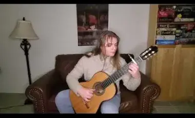 Misha playing classical guitar