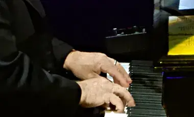 Two hands playing the piano
