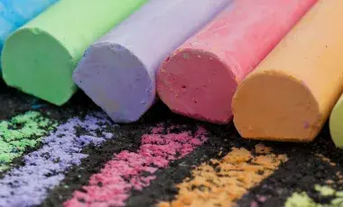 A row of lined up colorful chalks.