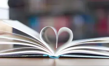 Picture of book pages folding into a heart 
