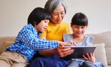 Grandmother reading to her two grandchildren