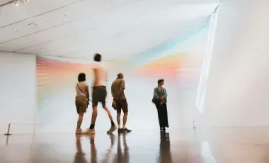 Four visitors observing a gallery